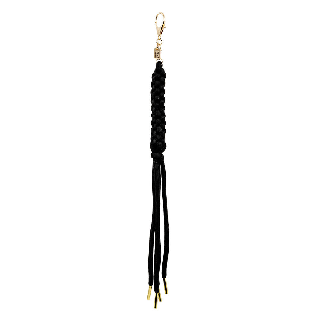 Sleek and bold, this black braided tassel charm adds a statement finish to any bag. The gold hardware adds a touch of glam, making it the perfect contrast piece.