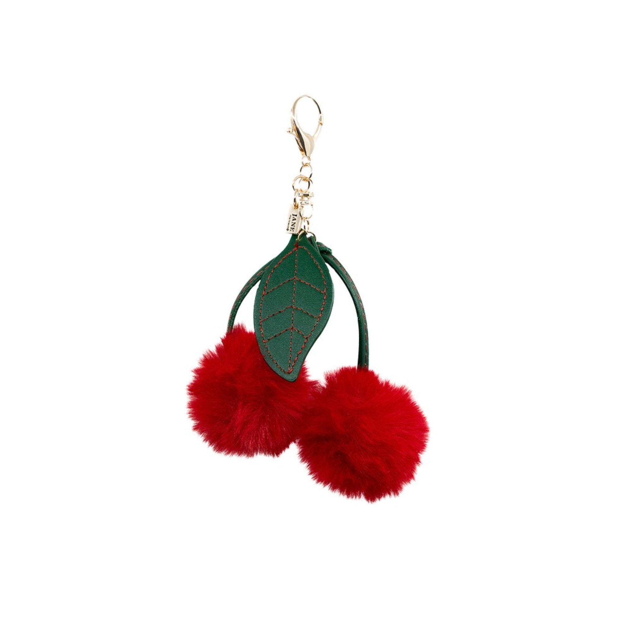 Add a playful pop of colour with this plush red cherry pom charm. Its soft texture and vibrant hue bring a whimsical flair to your accessories, making it a delightful addition to your bag or keychain. A sweet way to express your fun-loving personality.