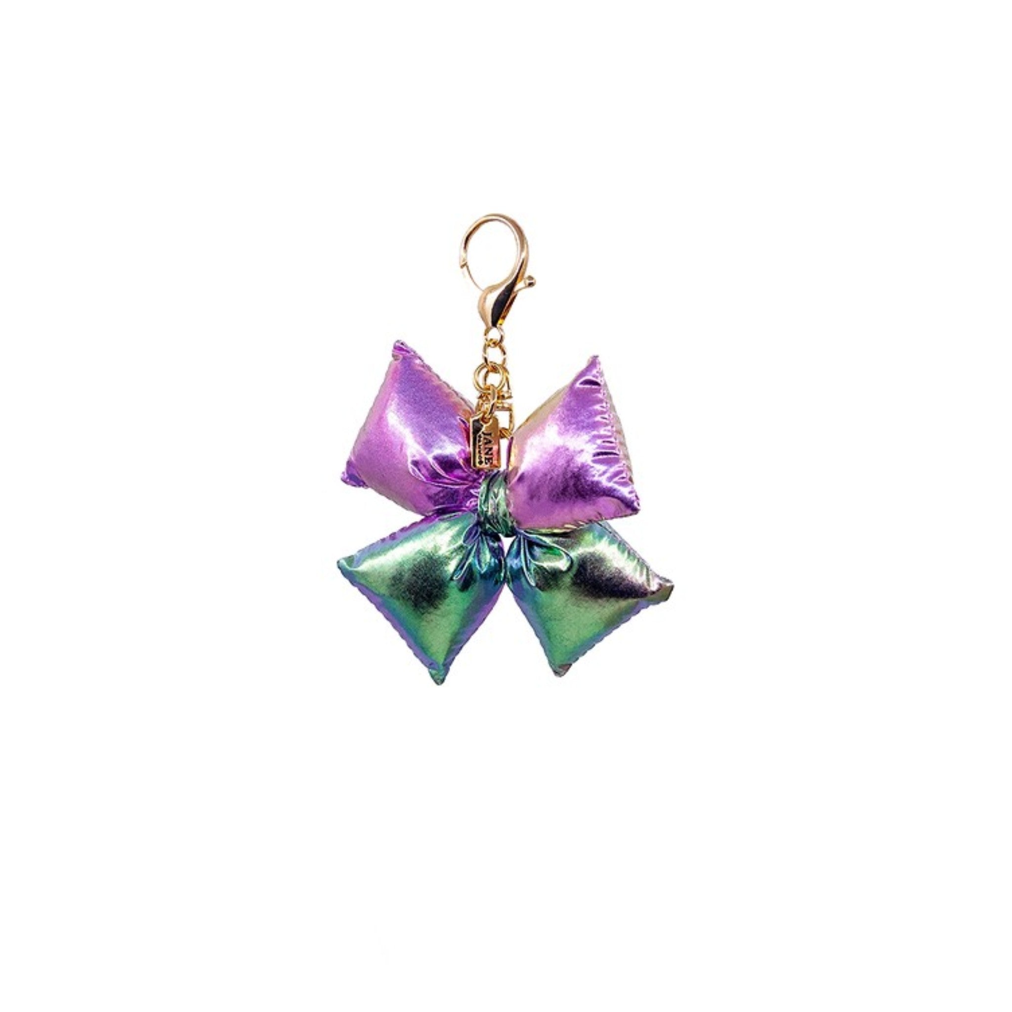 Add a playful pop to your accessories with this iridescent purple puffy bow charm. Its shimmering finish and charming design bring a whimsical flair, making it a delightful addition to your bag.