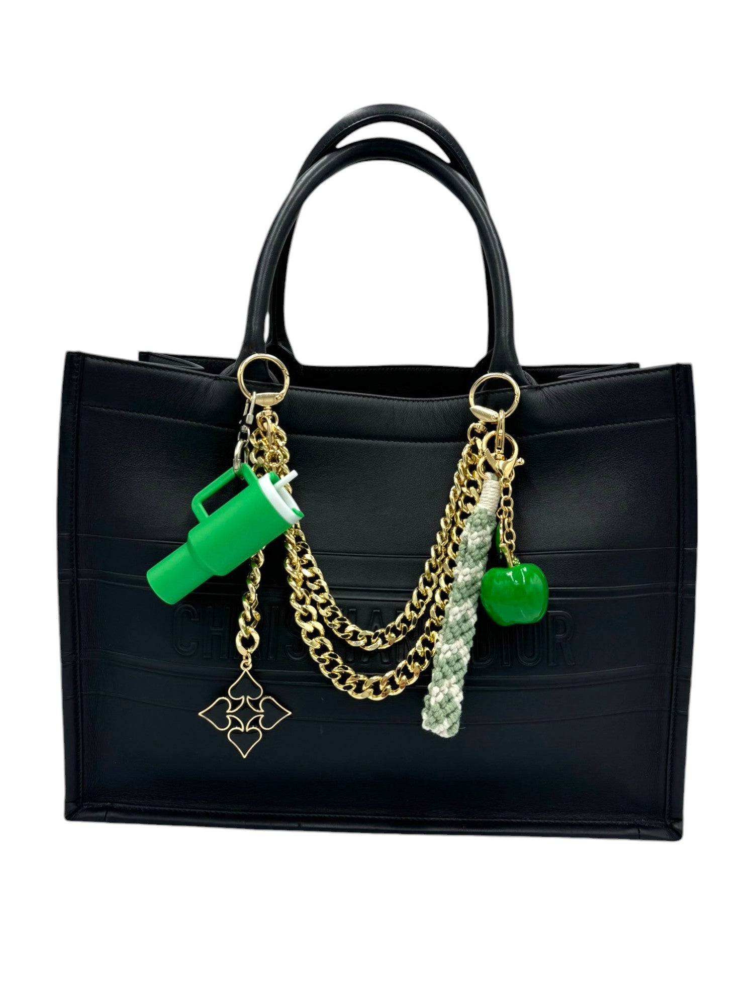 Handcrafted with intricate knots, this charm combines green and white threads, offering a boho-chic look that complements any style.