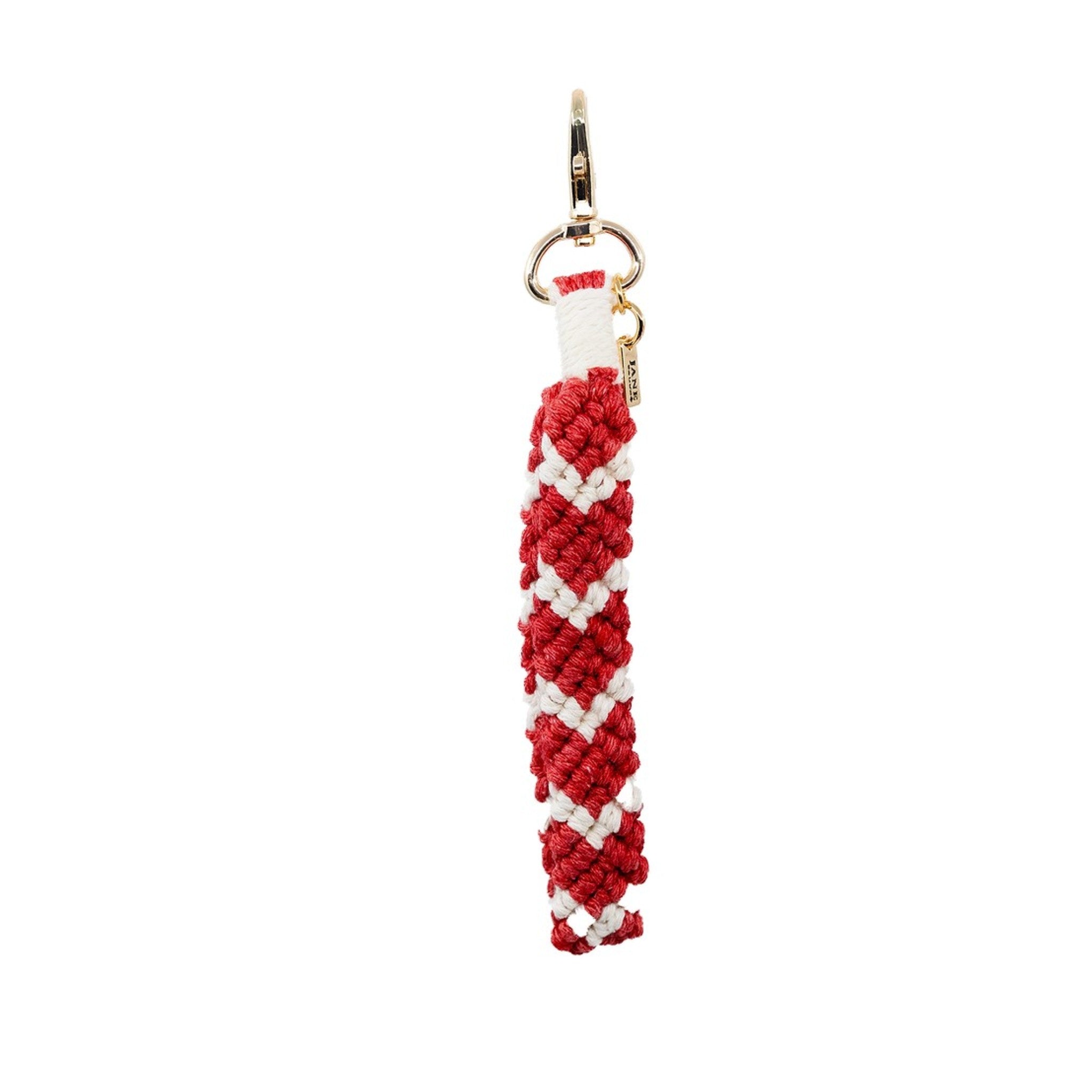 Handcrafted with intricate knots, this red and white macrame charm offers a boho-chic look. Its unique design adds texture and style, making it a versatile accessory for various occasions.