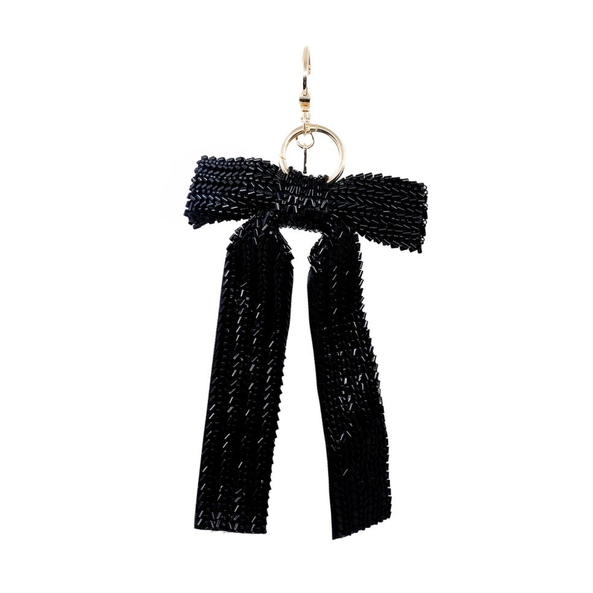 This classic black beaded bow charm exudes timeless elegance. Its intricate beadwork and sleek design make it a versatile accessory, perfect for adding a touch of sophistication to your bag. Ideal for those who appreciate understated glamour.