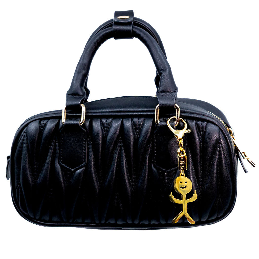 Black handbag with a gold charm no fucks middle finger