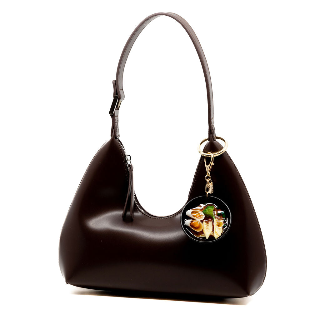 Slurp-worthy style in miniature form. The ramen charm features rich detail with lifelike ramen noodles and veggies. It’s the perfect charm for foodies, ramen lovers, and anyone craving a little flavour in their bag game.