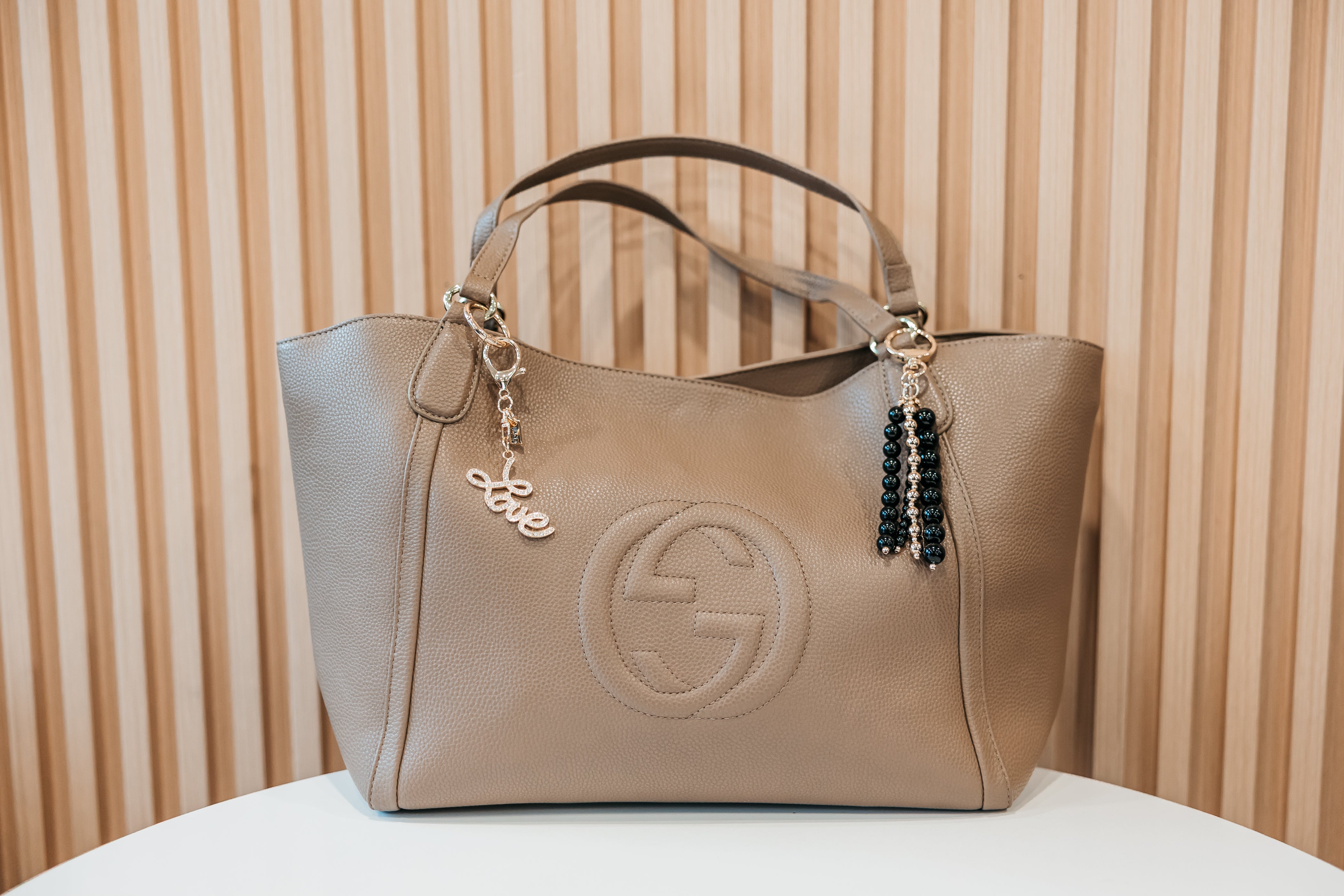 Beige handbag noir beaded charm love script charm jane the brand