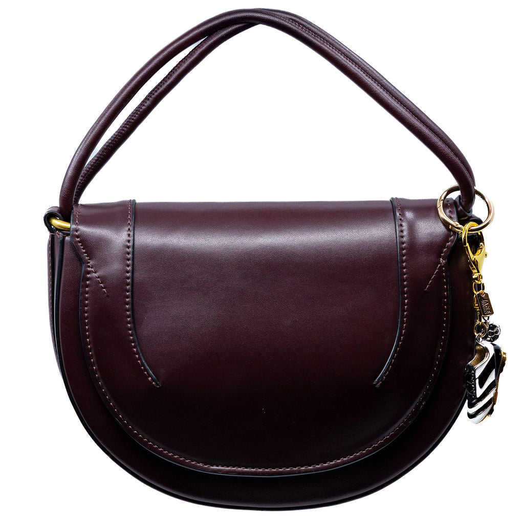 Brown leather handbag with a strap and decorative soccer charm