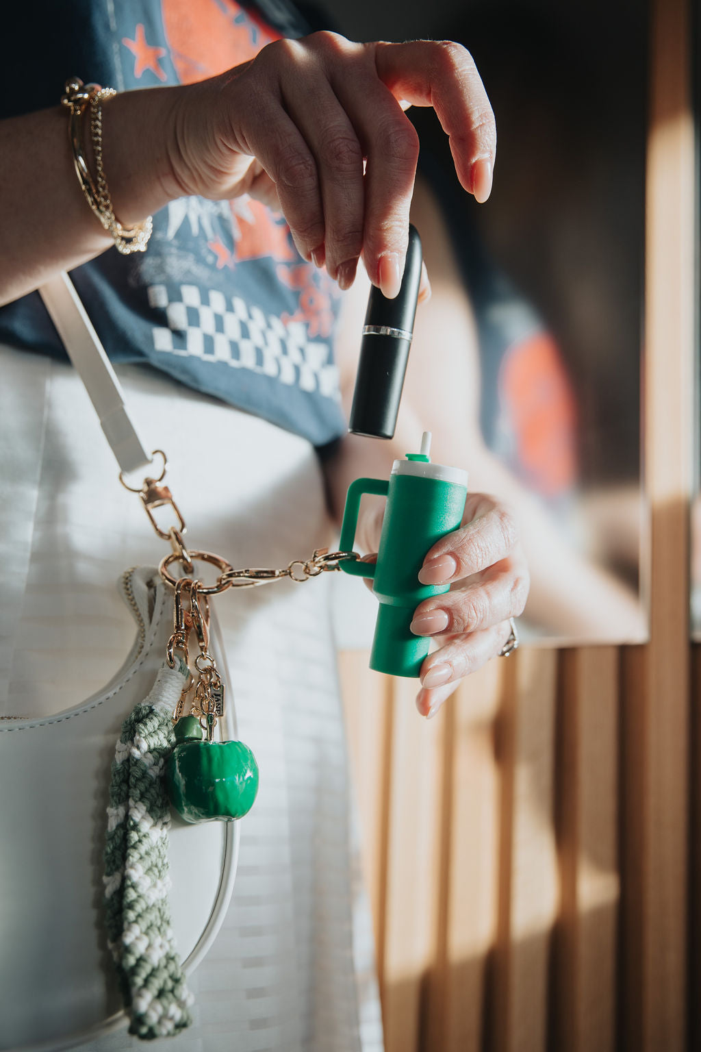 Person holding a green tumbler charm lipstick holder charm