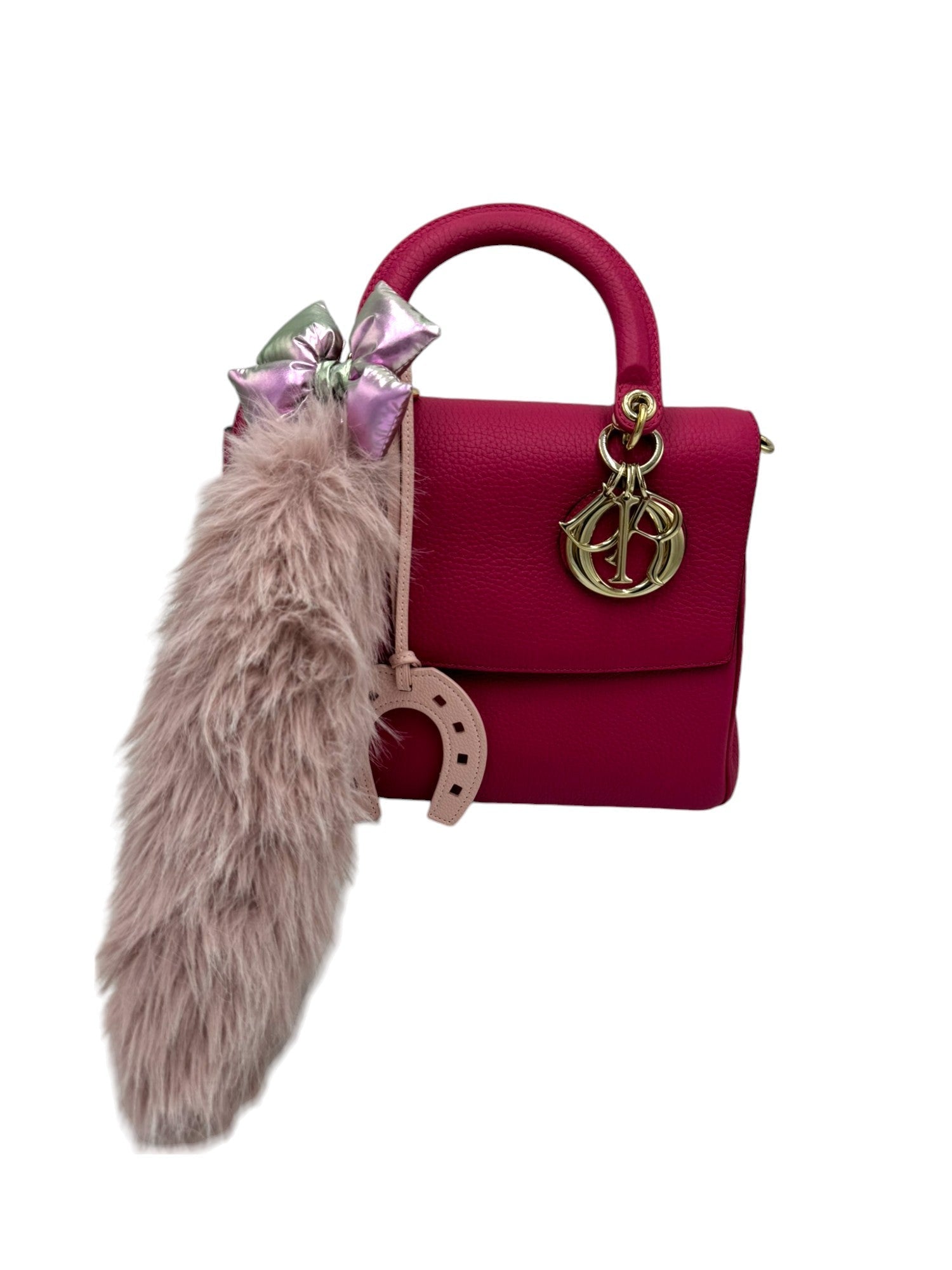 Embrace authenticity with this luxurious light pink faux-fur pendant charm. Its soft texture and elegant hue add a touch of sophistication to your accessories. Perfect for layering or as a standalone statement piece on your bag.