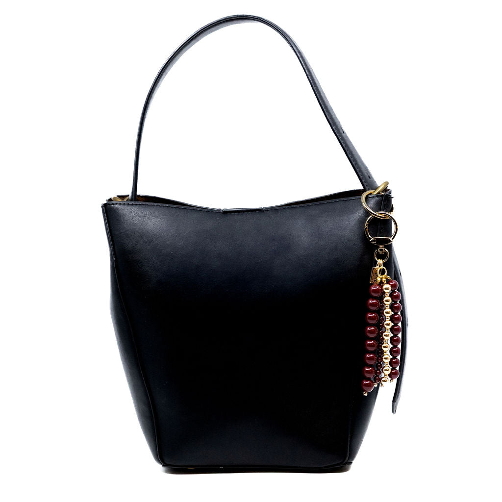 Black handbag with bag charm