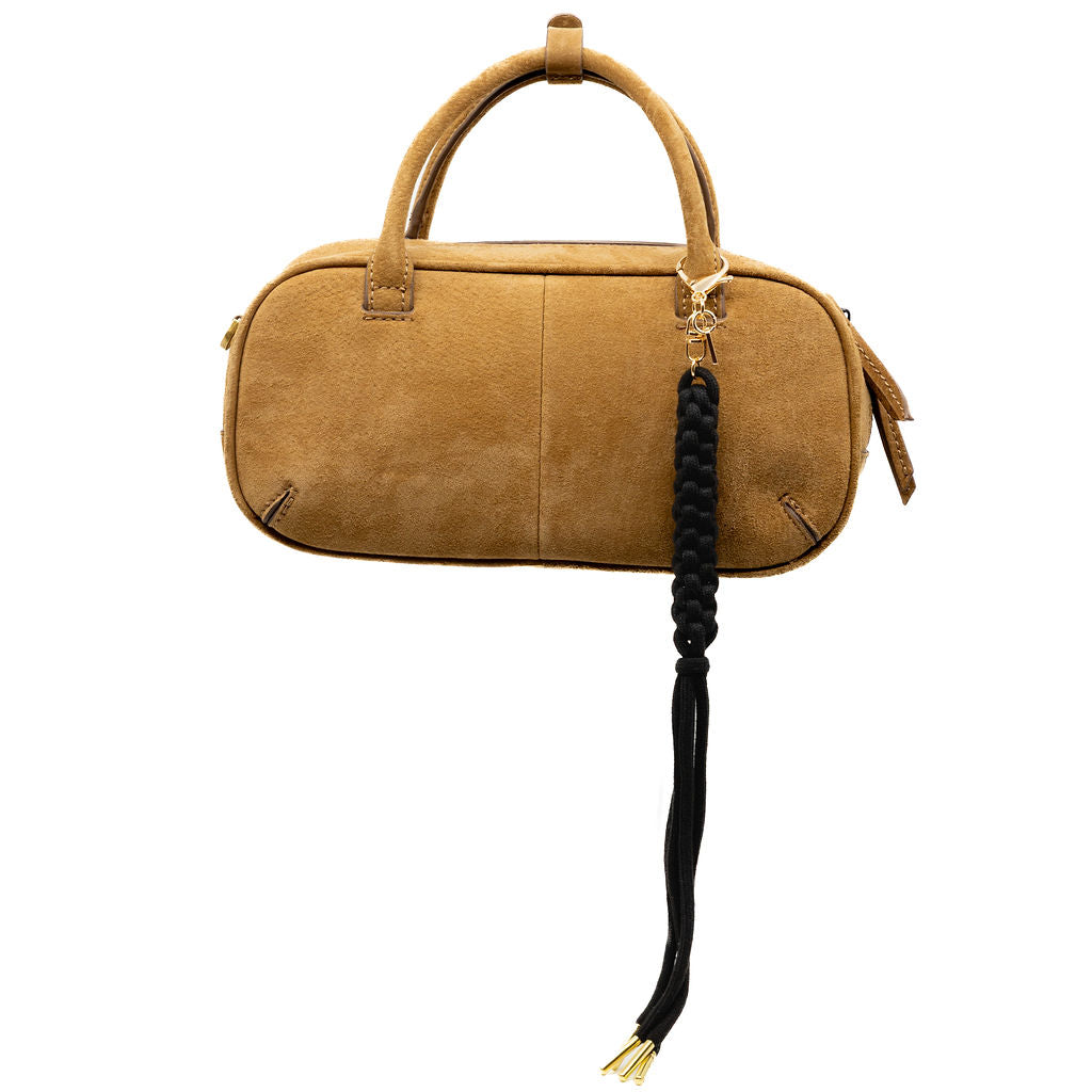 Sleek and bold, this black braided tassel charm adds a statement finish to any bag. The gold hardware adds a touch of glam, making it the perfect contrast piece.