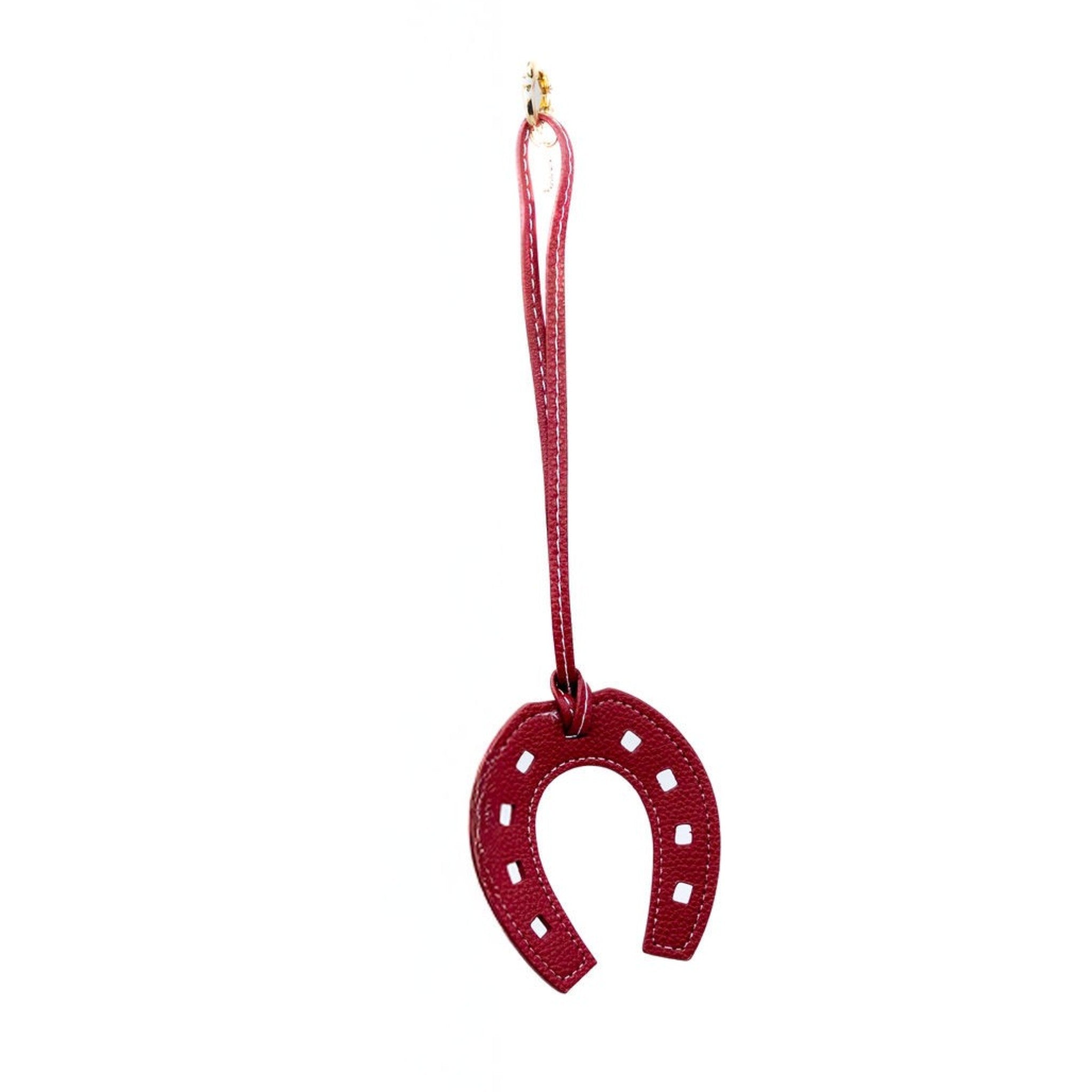 Infuse your ensemble with a bit of luck using this burgundy faux-leather horseshoe charm. Its bold colour and sleek design make it a standout piece, ideal for adding a meaningful touch to your bag.