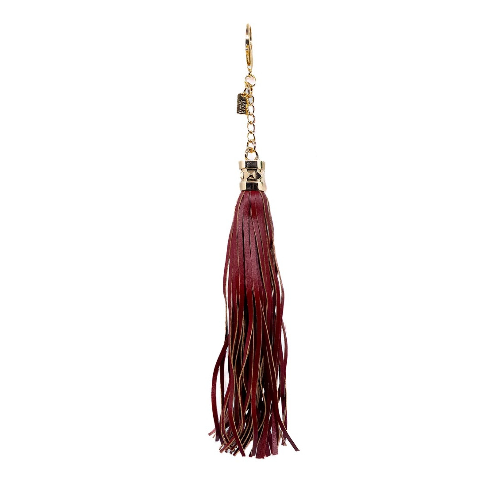 Bring a touch of bohemian flair with this burgundy faux-leather tassel charm. Its sleek design adds movement and texture, perfect for layering on your bag. The rich burgundy hue complements various styles, making it a versatile accessory for any occasion.