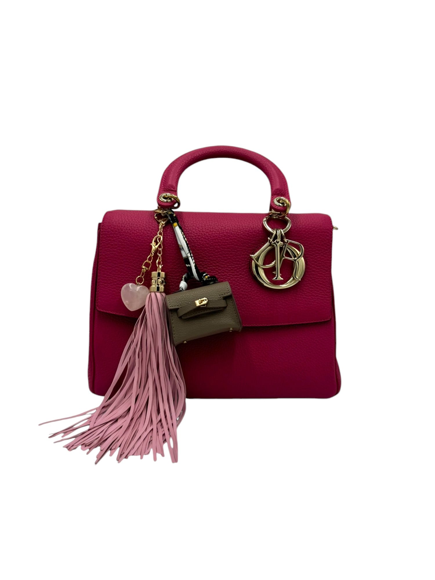 Bring a touch of bohemian flair with this pink faux-leather tassel charm. Its sleek design adds movement and texture, perfect for layering on your bag. The soft pink hue complements various styles, making it a versatile accessory for any occasion.