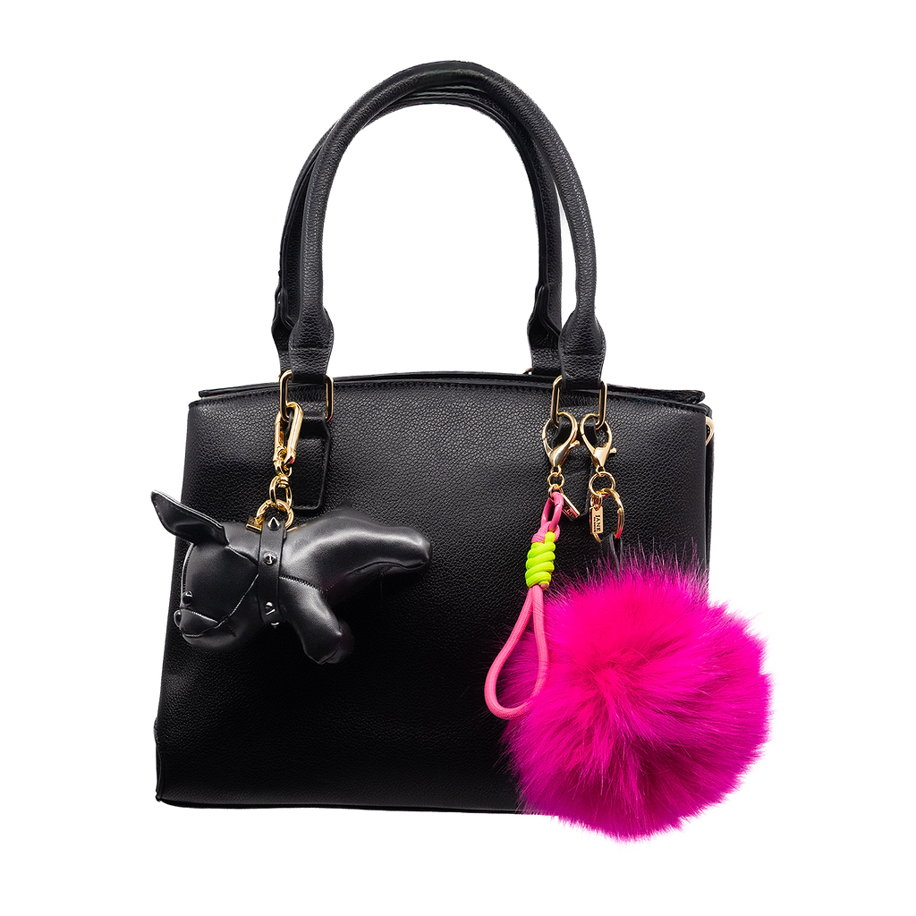 Brighten your ensemble with this large fuchsia faux-fur pom pom. Its playful colour and soft texture add a whimsical touch, reflecting a free-spirited personality.
