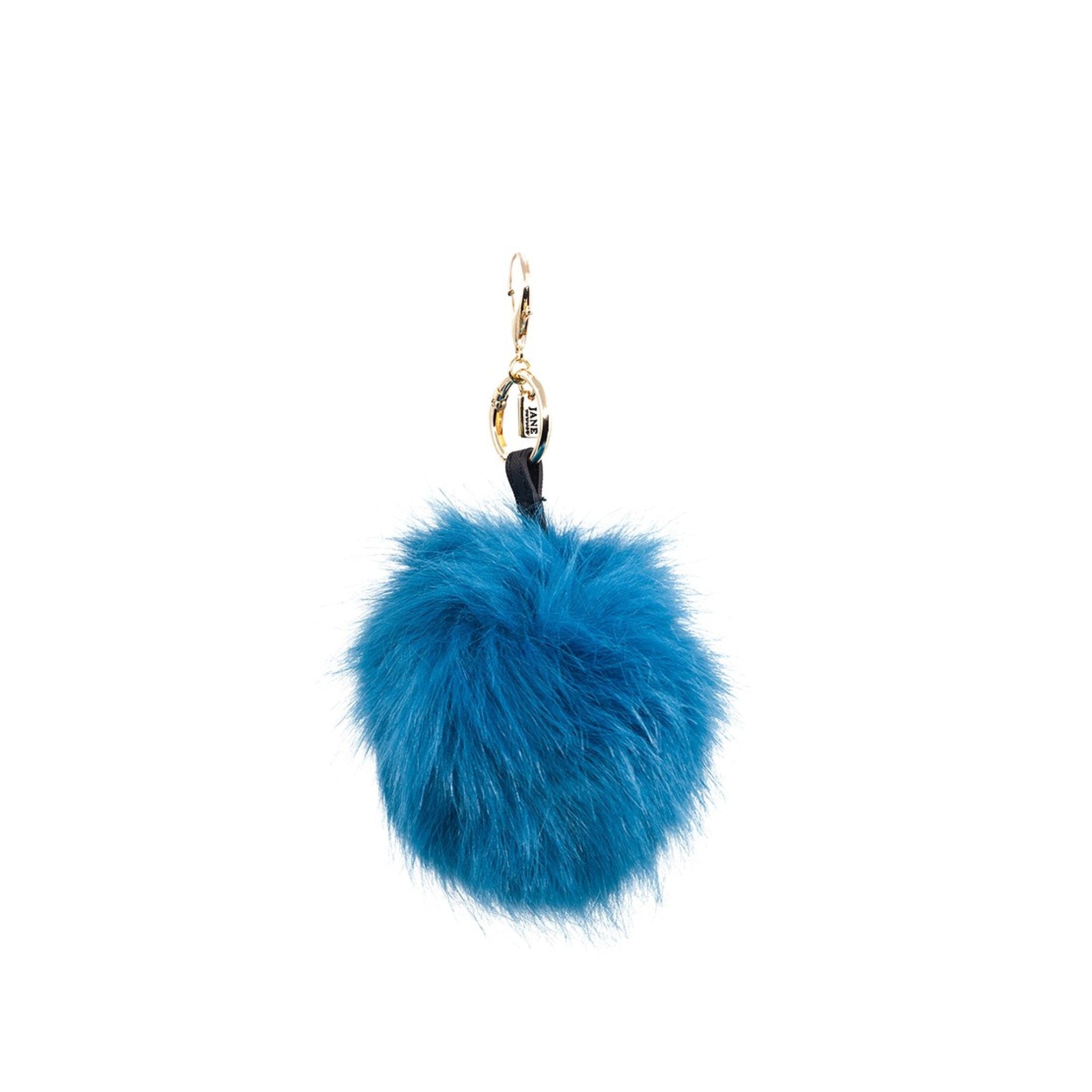 Add a playful pop of colour with this large blue faux-fur pom pom charm. Its soft texture and vibrant hue bring a bold statement to your accessories, making it a perfect addition for those who love to make a statement.