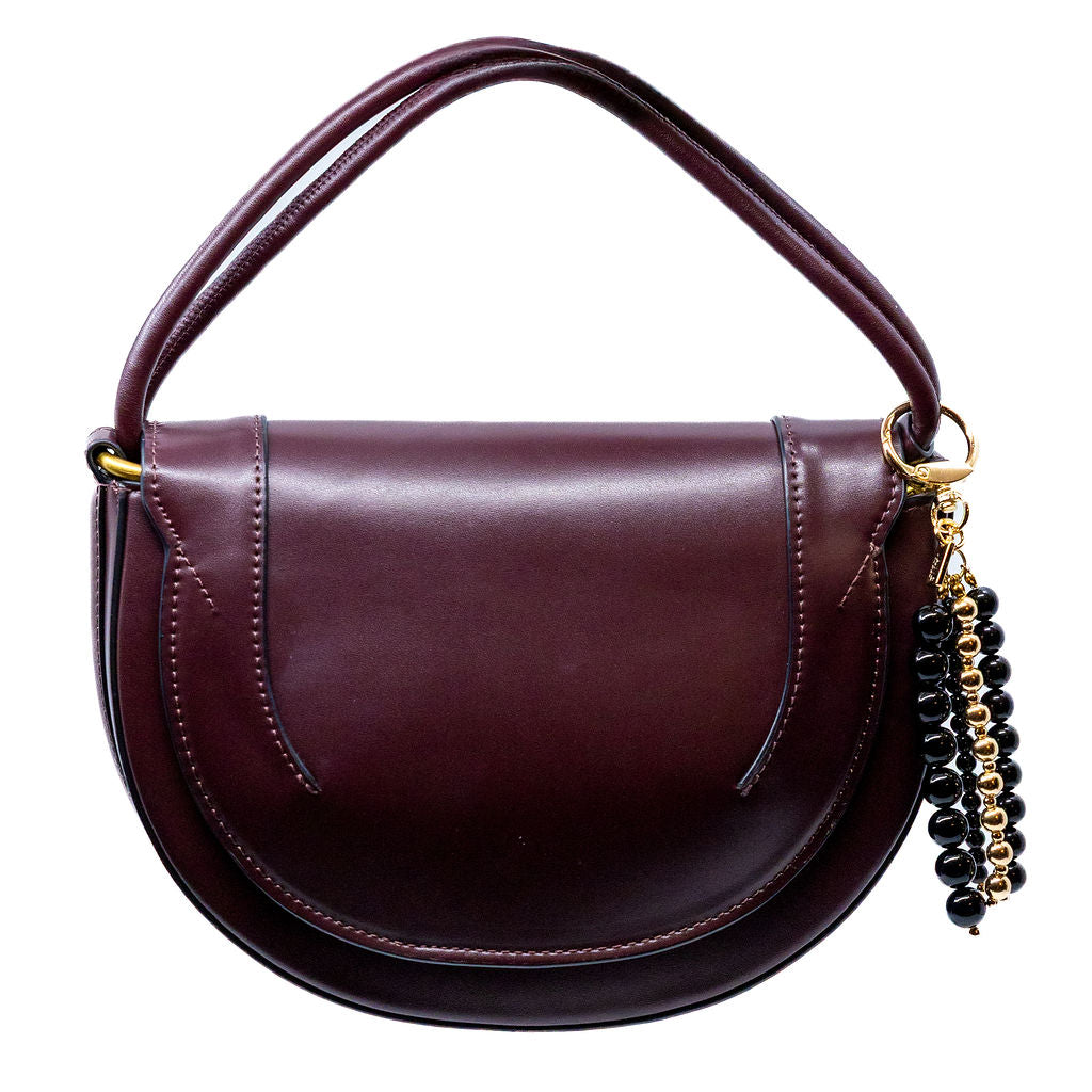 handbag with a decorative beaded charm