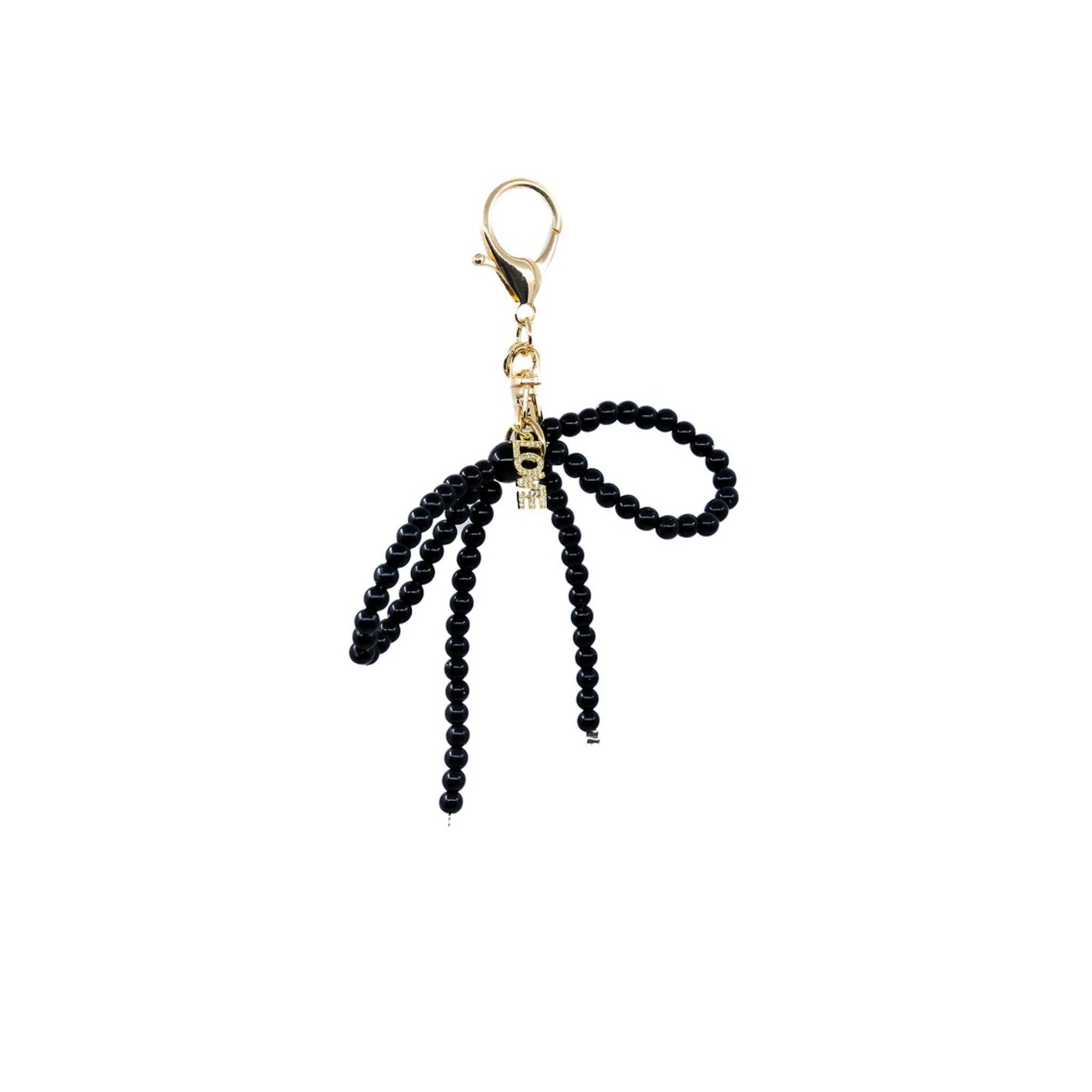 Add a dash of sophistication with this black pearl bow charm, featuring a delicate LOVE pendant. The lustrous pearls and the heartfelt message combine to create a piece that exudes charm and affection.