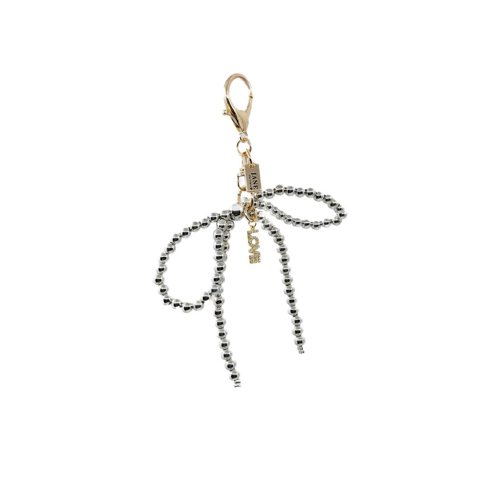 Elevate your accessories with this silver pearl bow charm, adorned with a mini LOVE charm. The lustrous pearls and delicate design bring a refined touch to your ensemble, symbolizing love and grace.​

