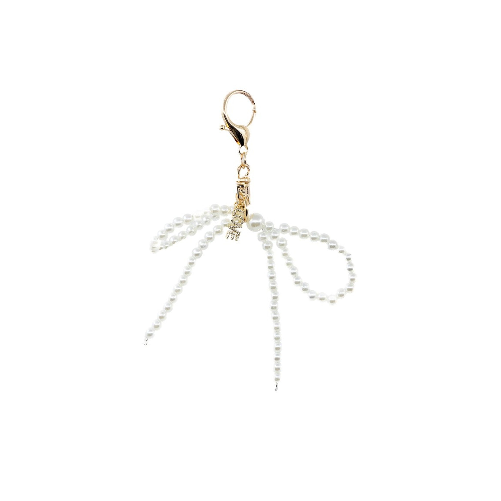 This white pearl bow charm features a delicate LOVE pendant. The crisp pearls and sparkly love pendant are the perfect combination and will stand out on every person day or night.&nbsp;&nbsp;