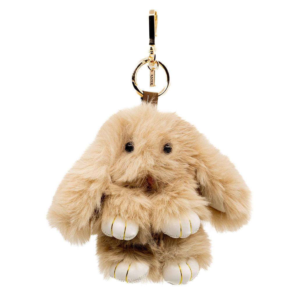 Meet your newest fuzzy friend. This mocha coloured bunny is soft, sweet, and neutral-toned—perfect to pair with any bag or keychain for a cozy-chic vibe.