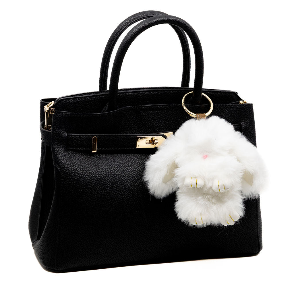 Snuggle up to our softest charm yet. This fluffy white bunny brings a cozy, luxe feel with its ultra-soft fur and floppy ears—perfect for where ever your day brings you.