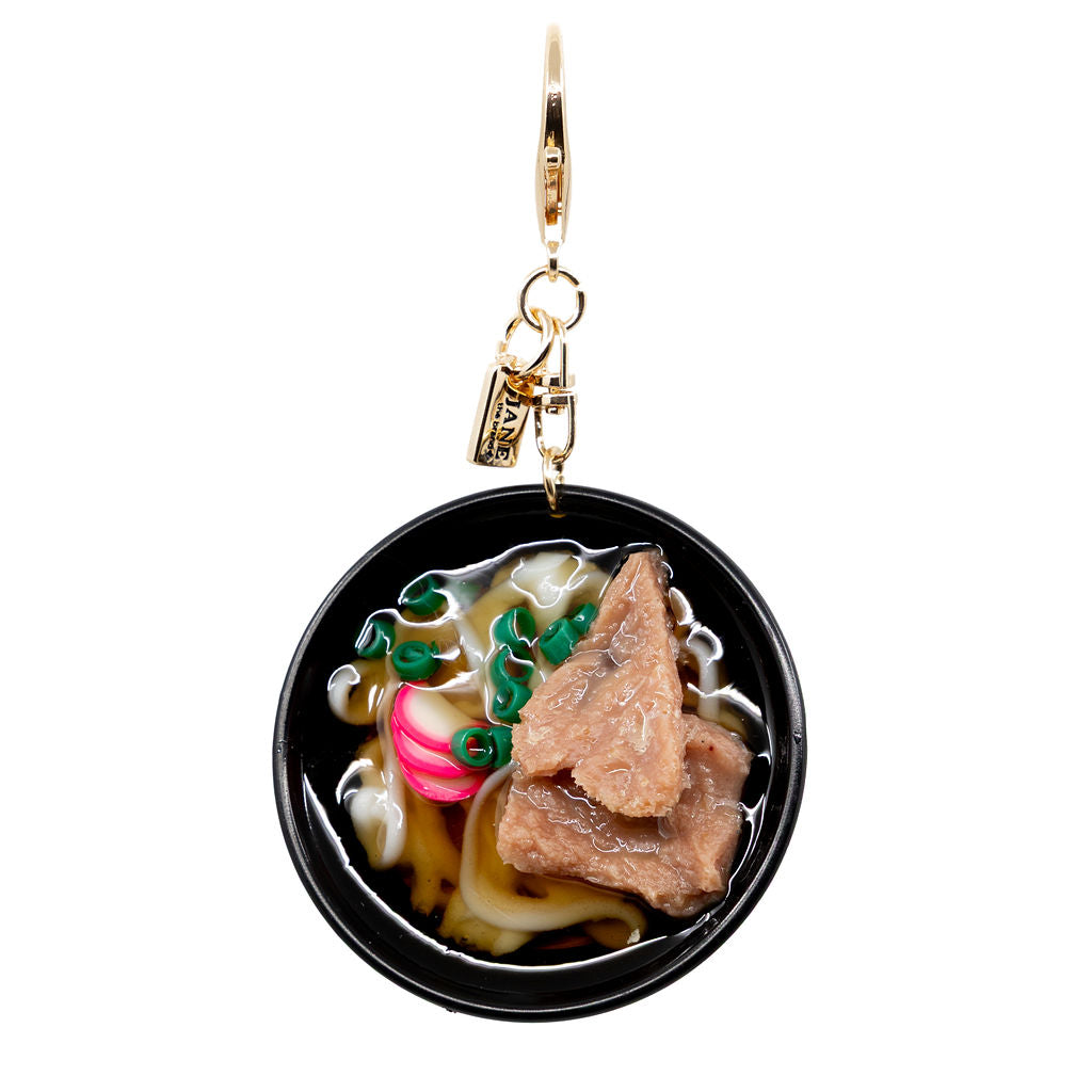 A steaming bowl of cozy for your purse. This playful charm features a hyper-detailed bowl of beef udon complete with noodles, sliced scallions, and pink narutomaki swirls.

Ramen Bowl Beef Charm