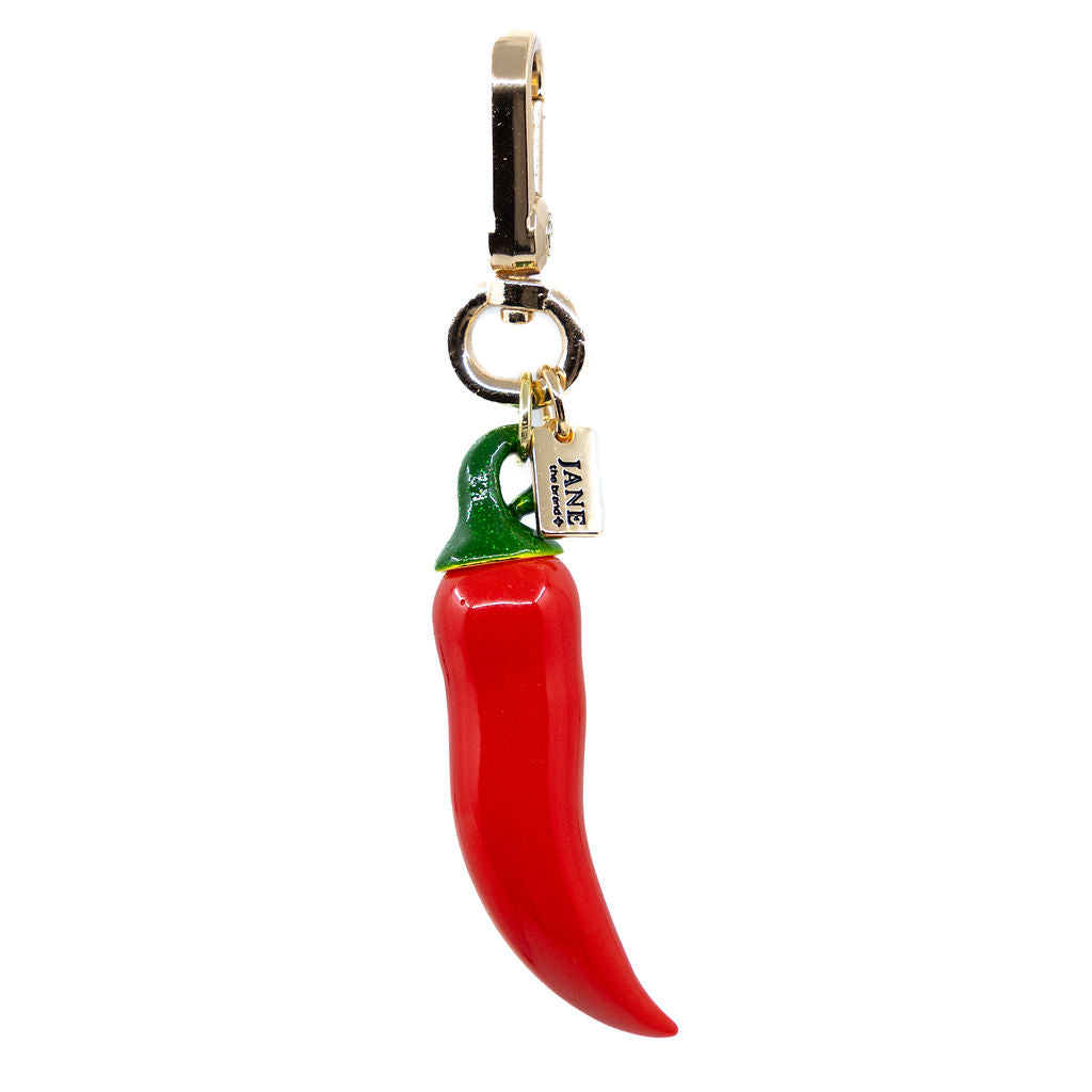 Red chilli pepper charm with a gold clasp on a white background