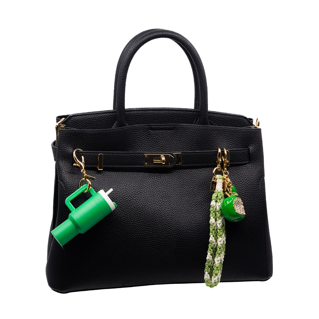 The Alexis Charming bag charm set features a Green Stanley cup charm paired with a green metal apple and green/white macrame, creating a vibrant accessory set