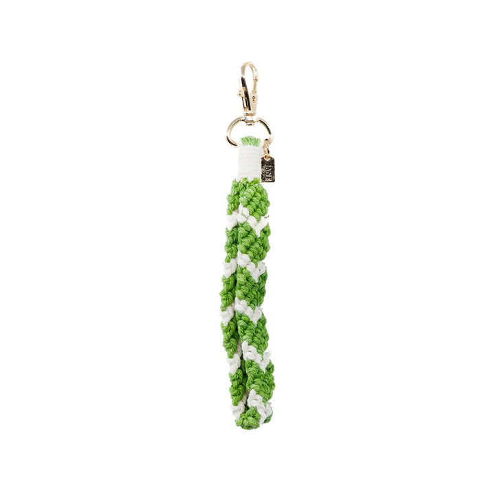 The Alexis Charming Bag Charm Set Features a green stanley cup charm paired with a green metal apple and green/white macrame, creating a vibrant accessory set.  Purse Charm Bag Charm