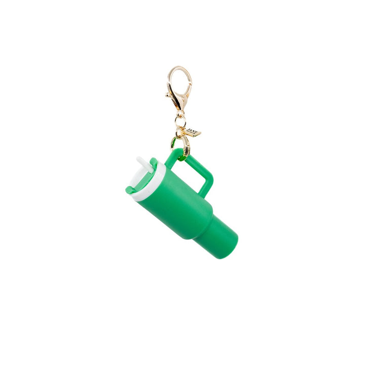 The Alexis Charming Bag Charm Set Features a green stanley cup charm paired with a green metal apple and green/white macrame, creating a vibrant accessory set.  Purse Charm Bag Charm