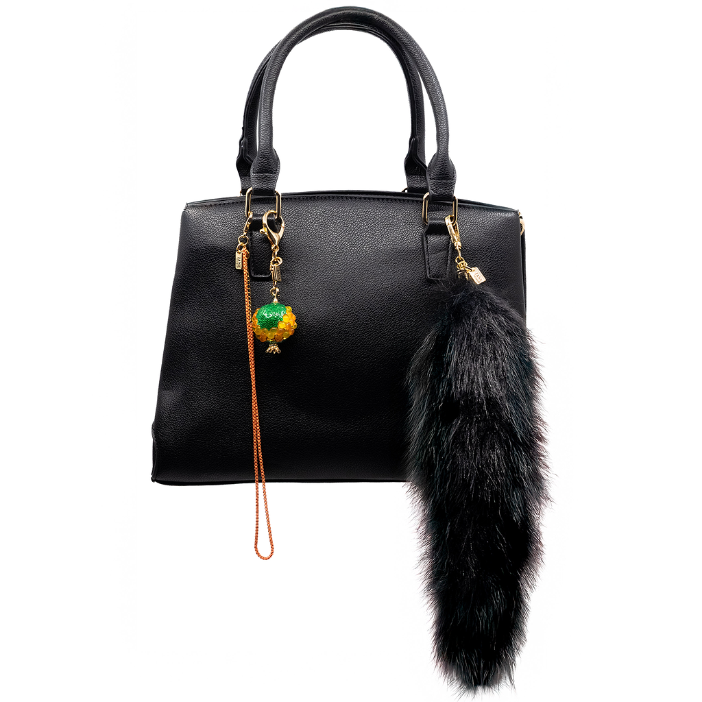 This dramatic black faux-fur pendant adds a bold and luxurious touch to your accessories. Its long, plush design brings a sense of elegance and flair, making it a standout piece for any ensemble.