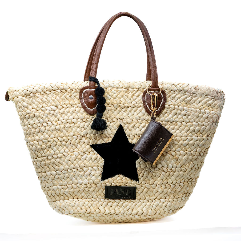 Woven handbag with star detail and brown handle on a white background